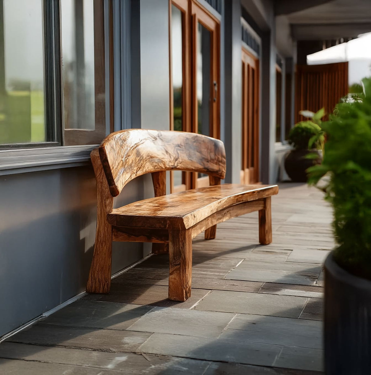 Solid wood outdoor seating displayed beside a pool in an organic modern garden