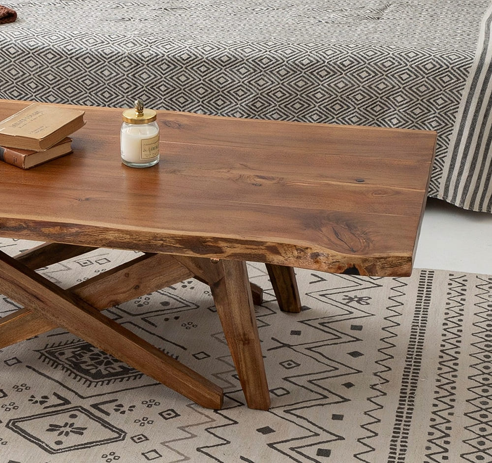 Organic modern coffee table featuring natural live edge details and a rustic X-shaped base