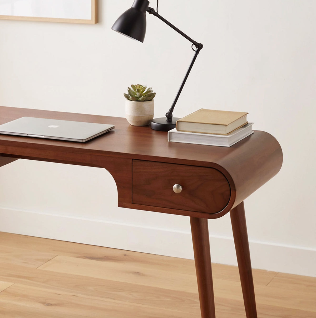 Solid wood writing desk featuring organic curved lines and built-in drawers