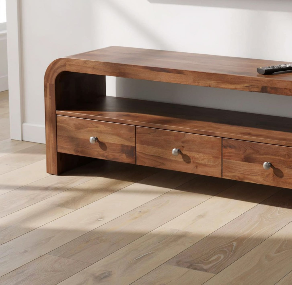 Modern curved solid wood media console featuring functional drawer storage