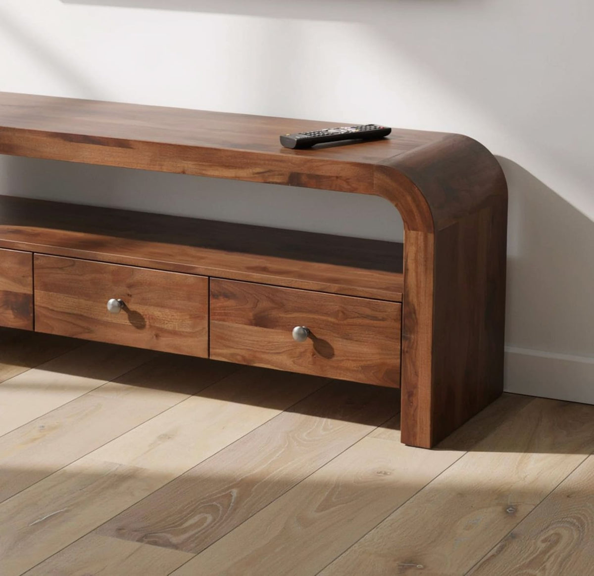 Modern curved solid wood media console featuring functional drawer storage