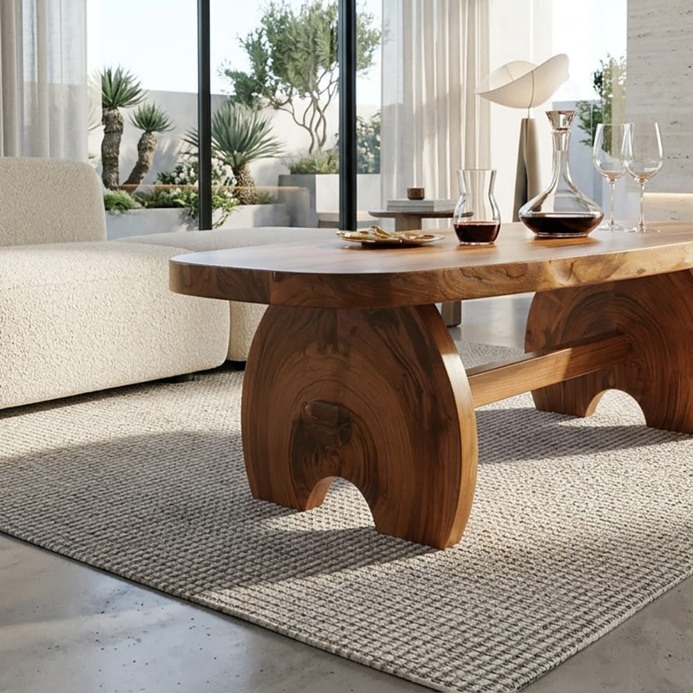 Oval slab coffee table in solid wood with a sculptural crescent base