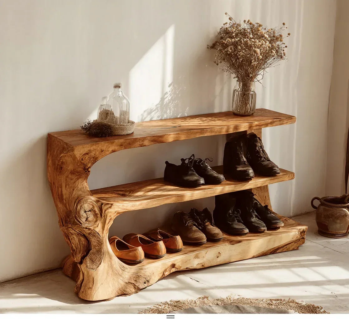 Live edge solid wood shoe rack with natural finish, holding shoes and decor by a white wall