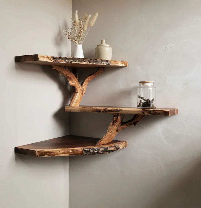 Rustic live edge wooden corner shelves with natural wood brackets, decorated with dried flowers and glass jar, Solid hardwood planks next to a finished natural wood corner bookshelf showing material quality