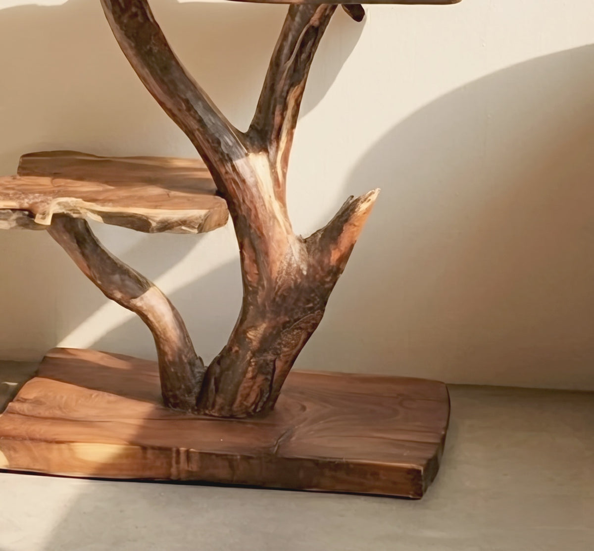 Handcrafted solid wood nightstand with tree branch details in a cozy bedroom