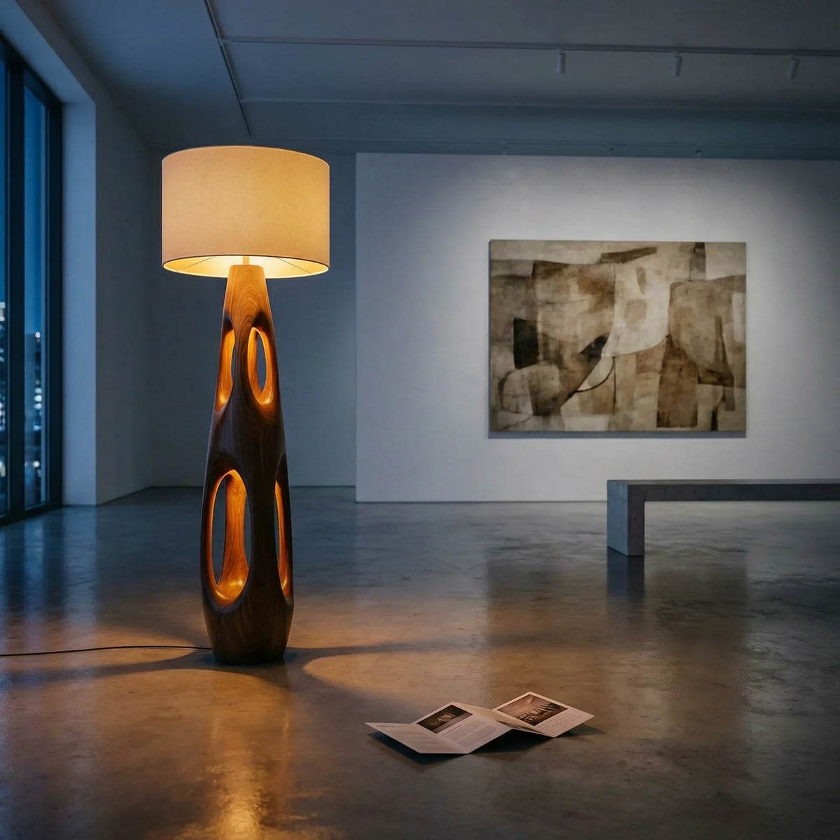 Carved wood floor lamp with dual openings and fabric shade in a modern living room