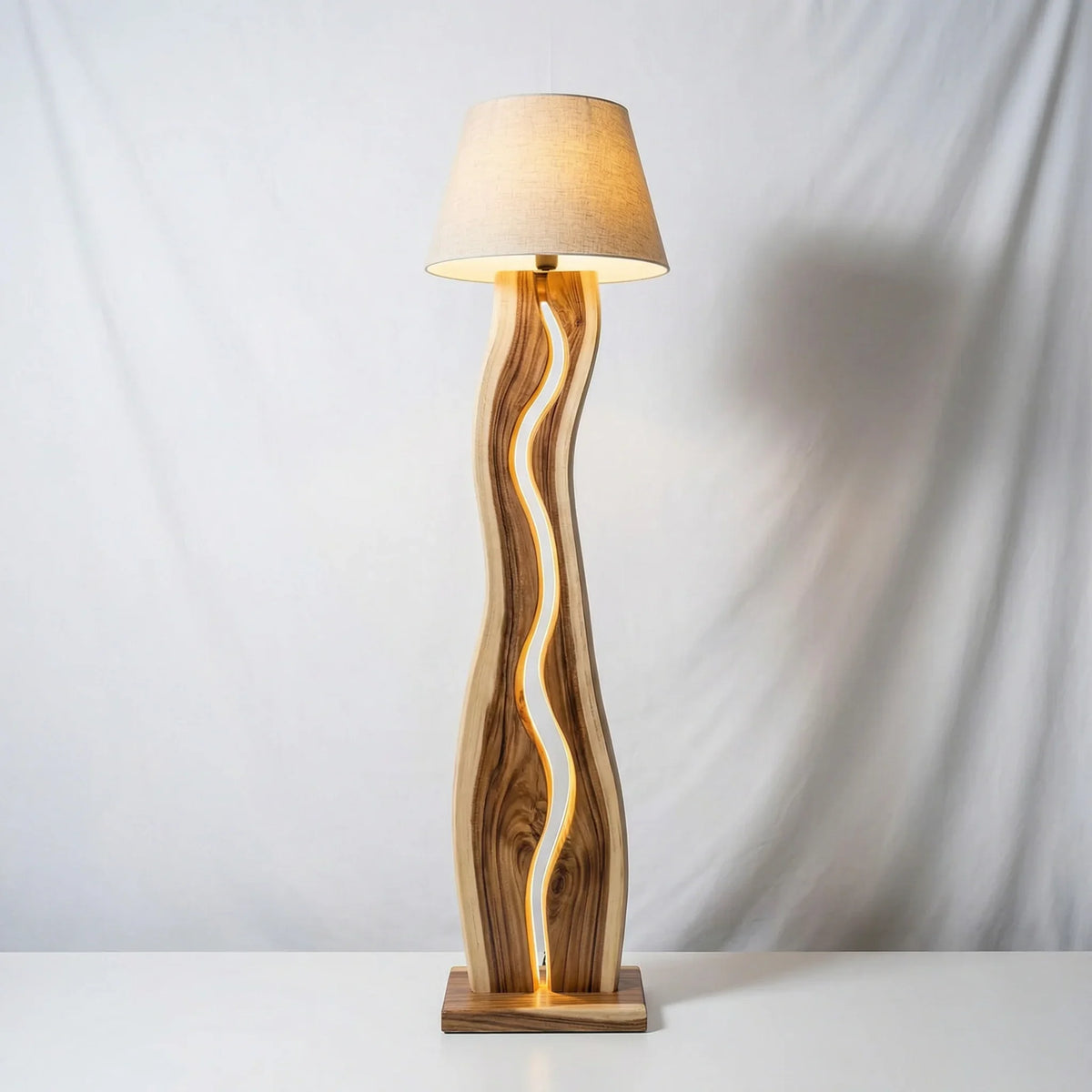Modern wavy wood floor lamp with LED strip and beige lampshade on white background