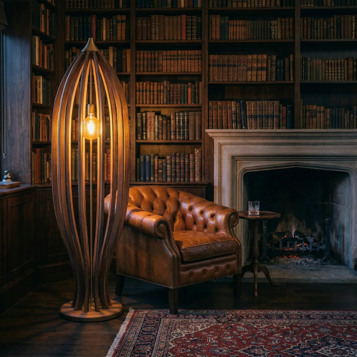 Wood cage floor lamp with Edison bulb beside leather armchair in rustic library