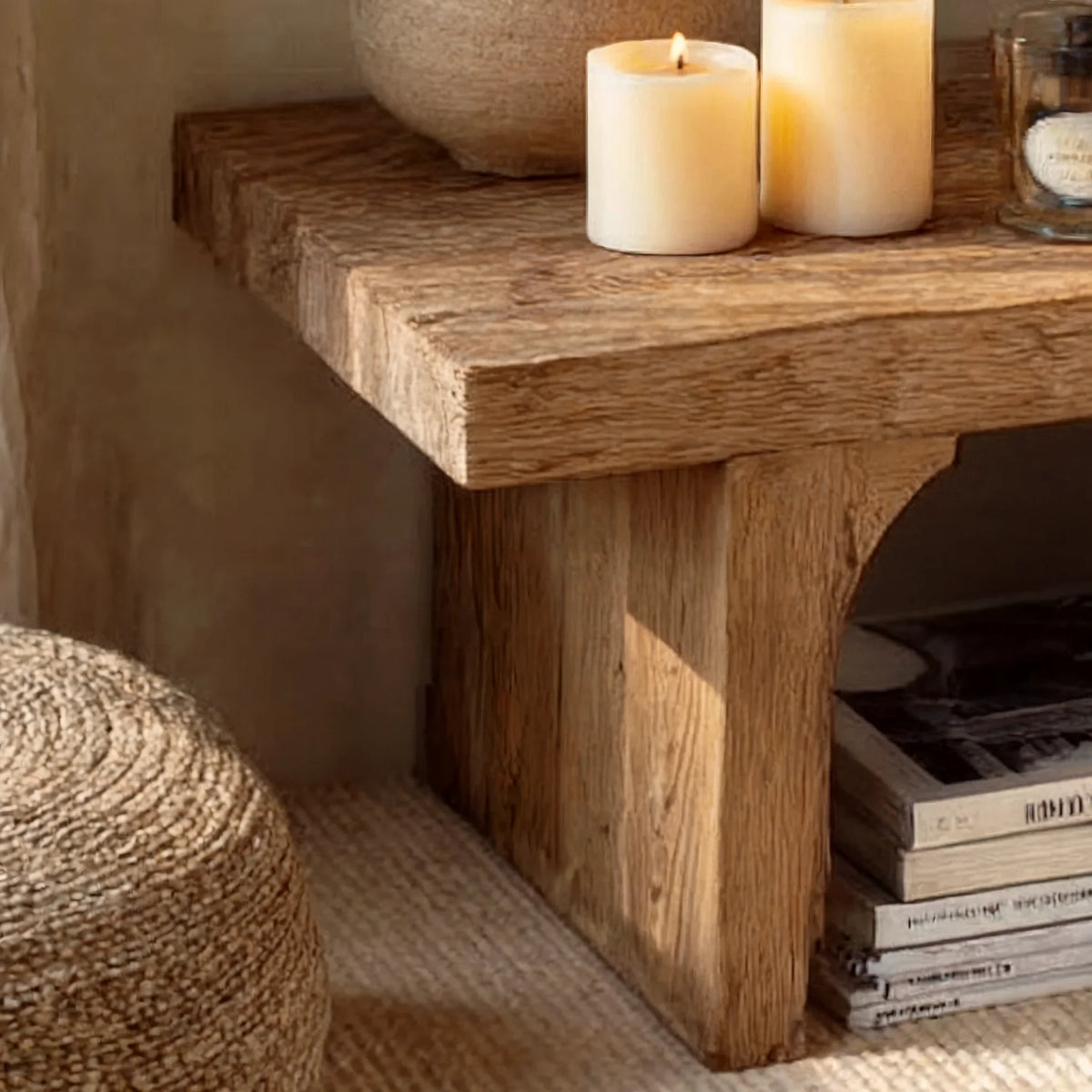 Close-up of rustic solid wood table with natural texture, candles, and books in cozy setting