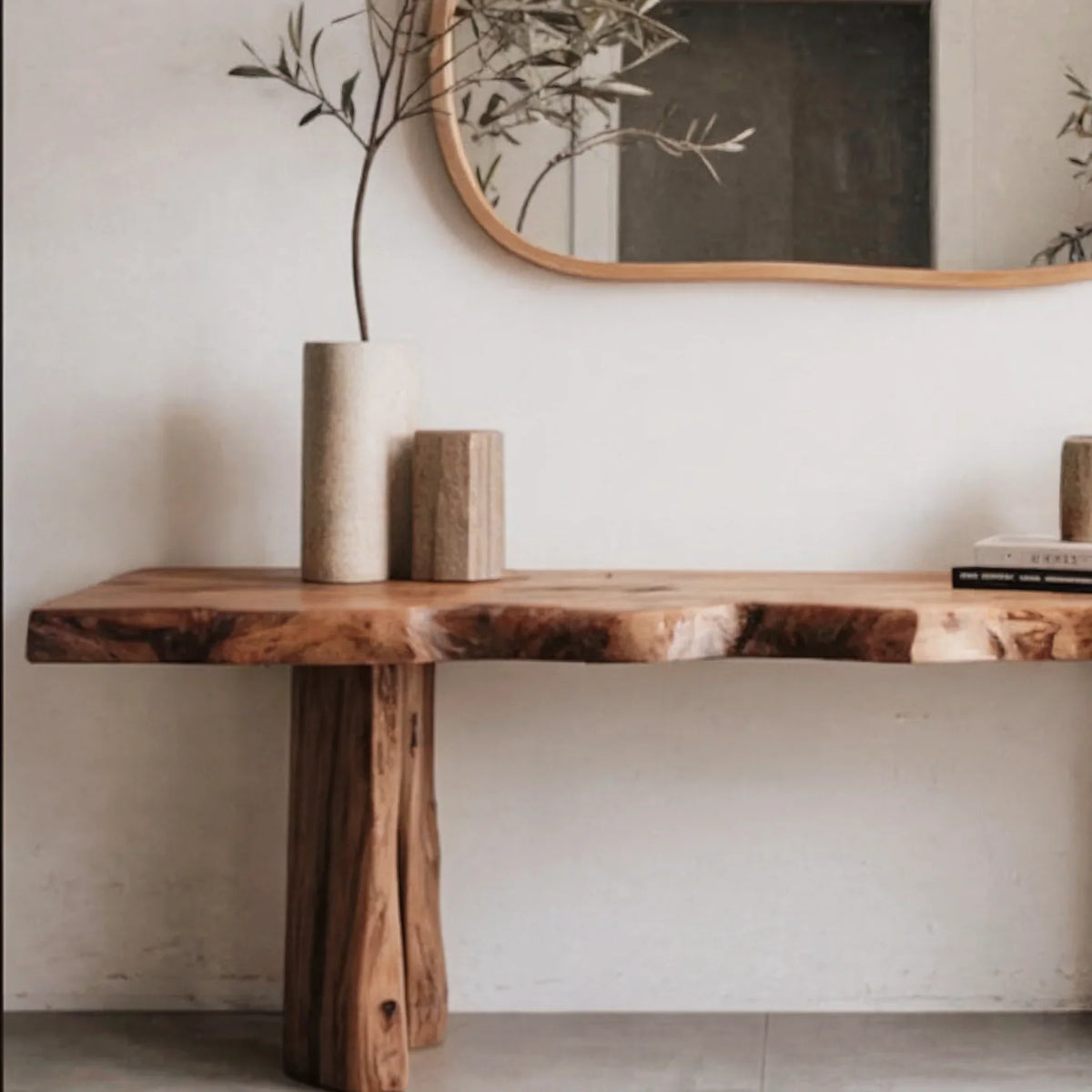 Minimalist living space with a live edge solid wood console table, ceramic vases, and wall mirror.