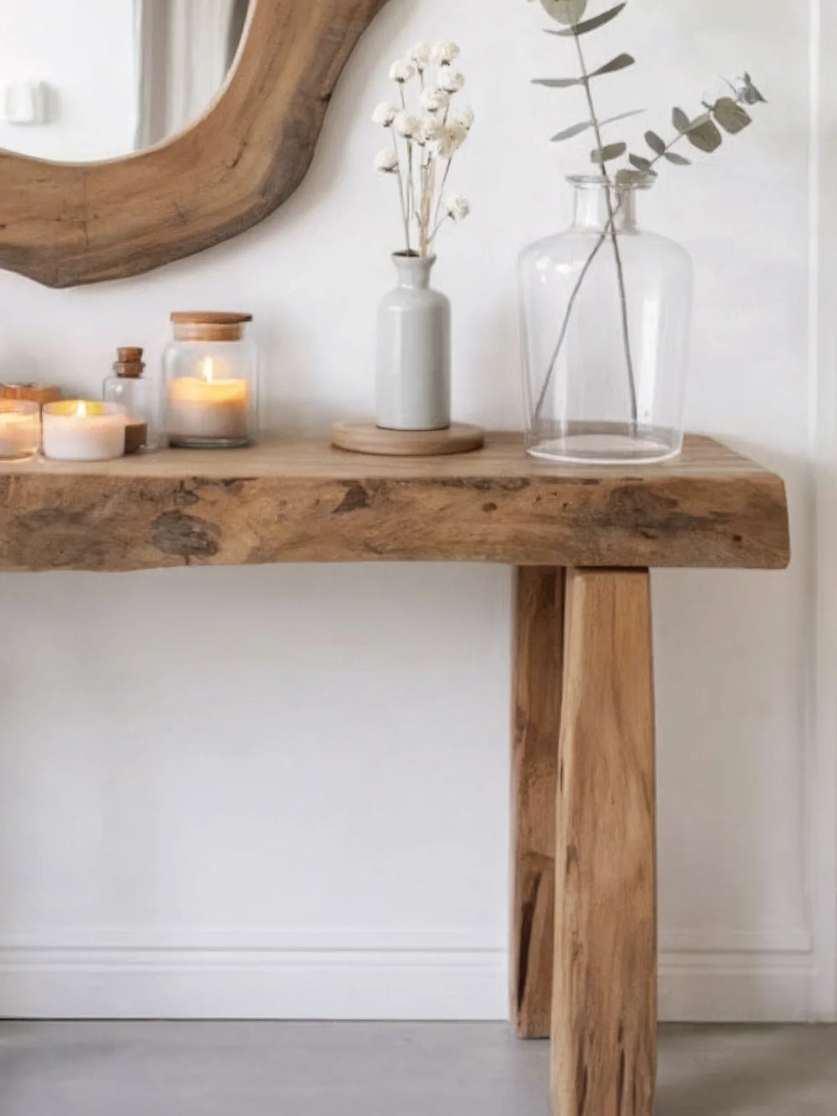 Minimalist solid wood console table with candles, glass vase, and modern decor accents