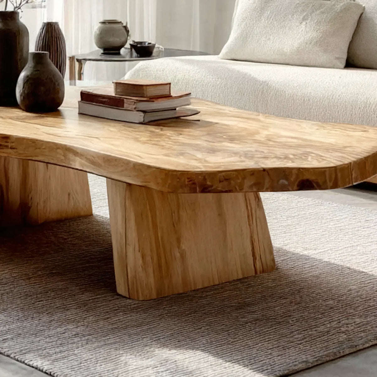 Modern living room with a live edge solid wood coffee table and neutral decor.