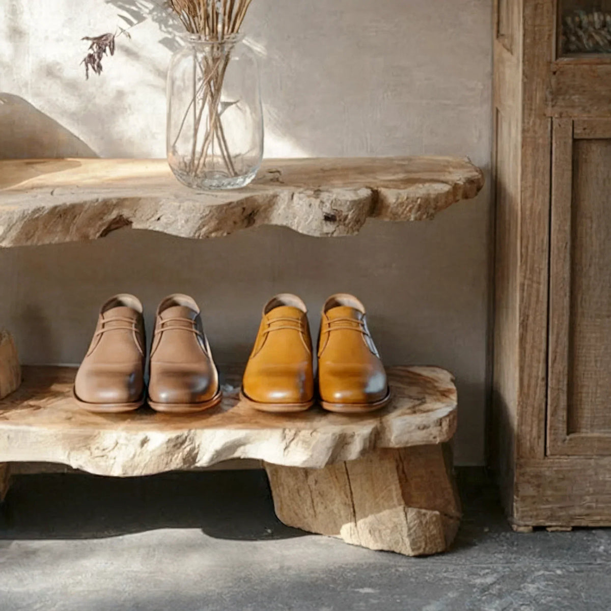 Two pairs of leather dress shoes on rustic live edge wood shelves, natural decor style