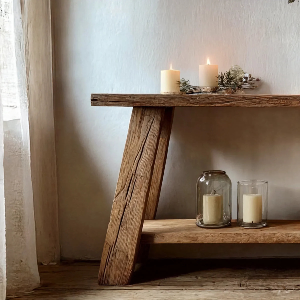 Rustic solid wood console table with candles and natural decor in a cozy setting