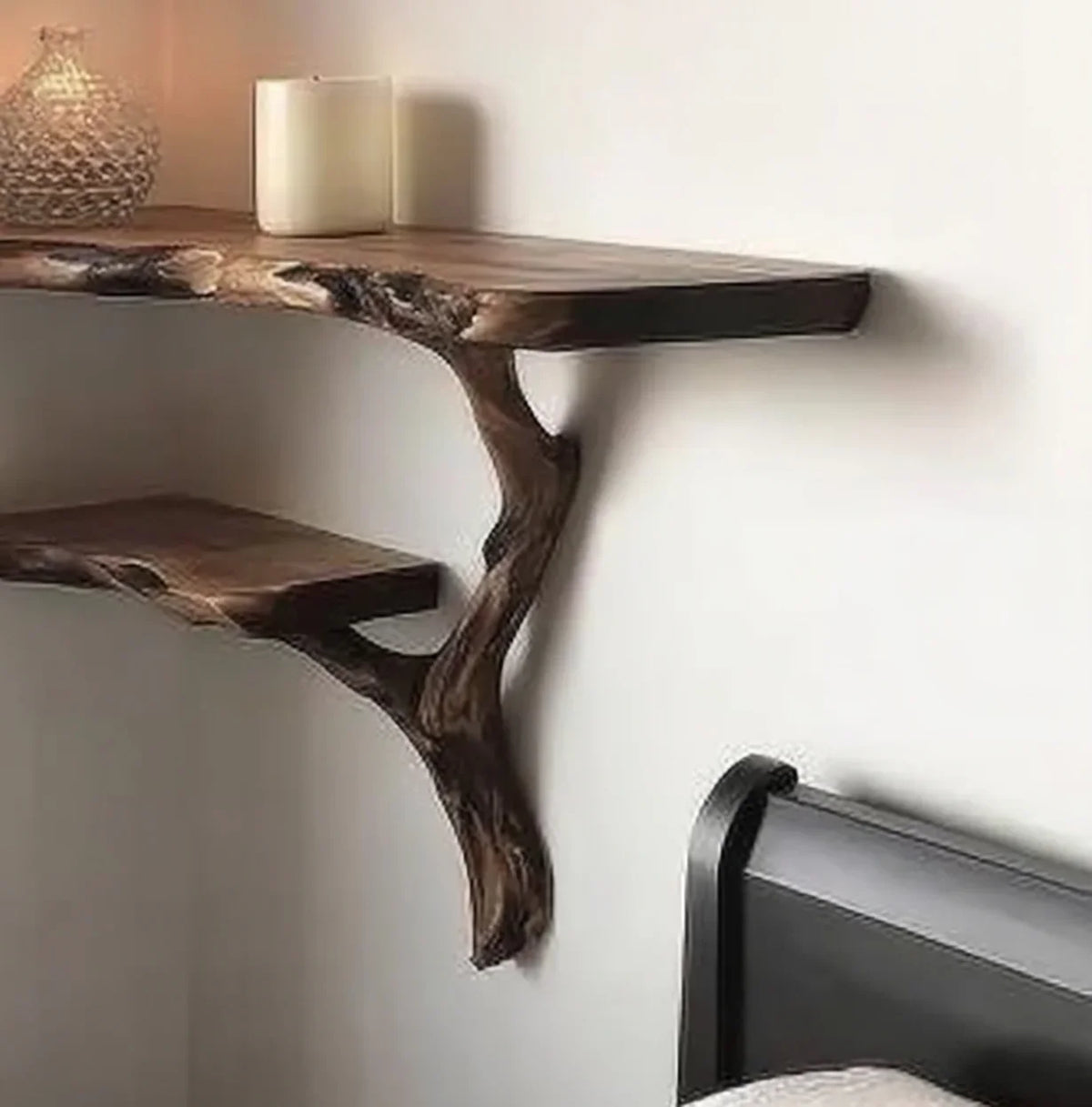 Live edge solid wood floating shelf with natural branch design mounted above a bed