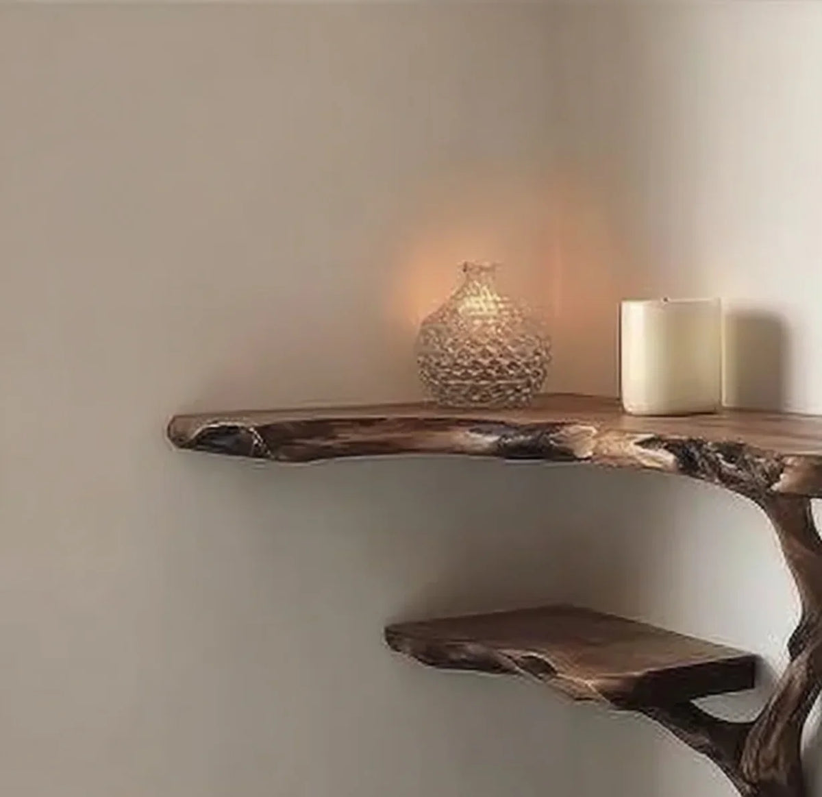 Live edge floating wood shelf with decorative candle and glass vase on neutral wall
