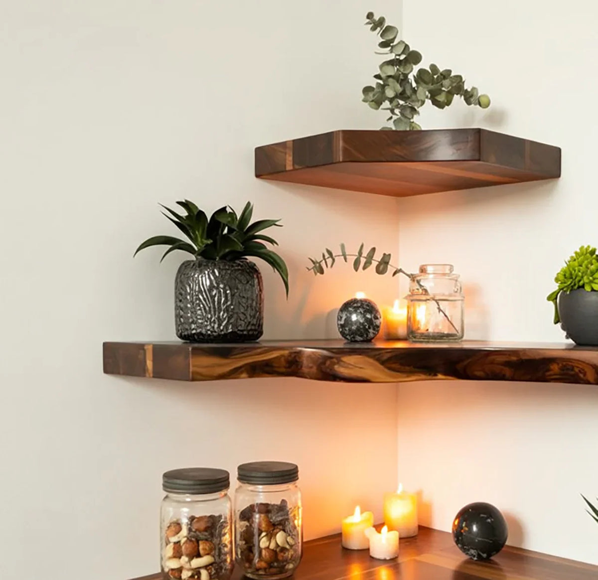 Live edge floating wood shelves with candles, plants, and decorative jars in a cozy corner.