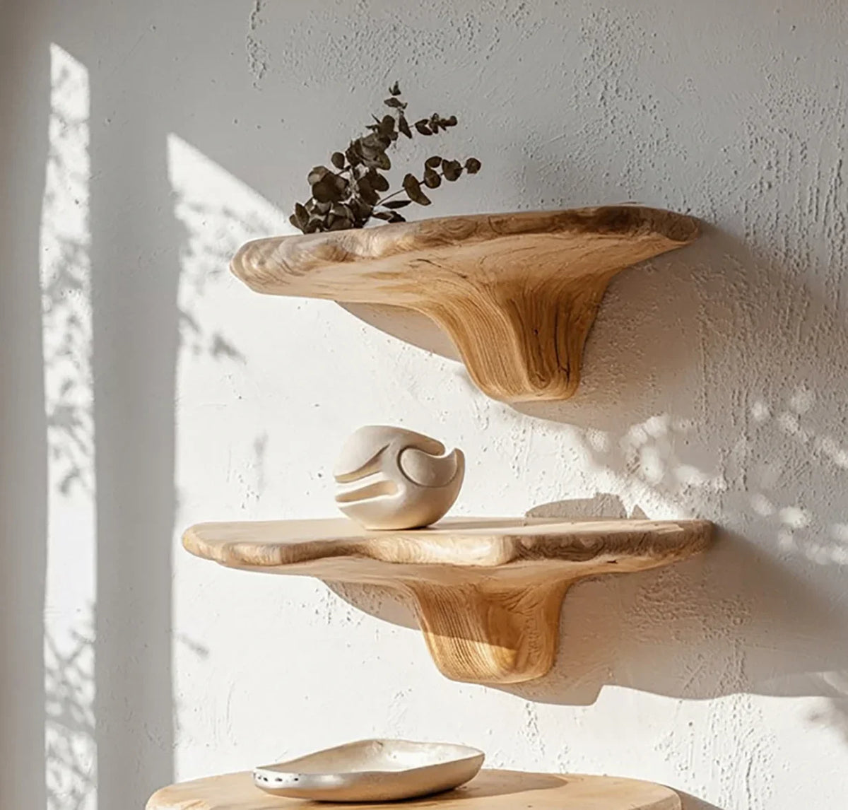 Handcrafted live edge wooden floating shelves on a textured wall with minimalist decor