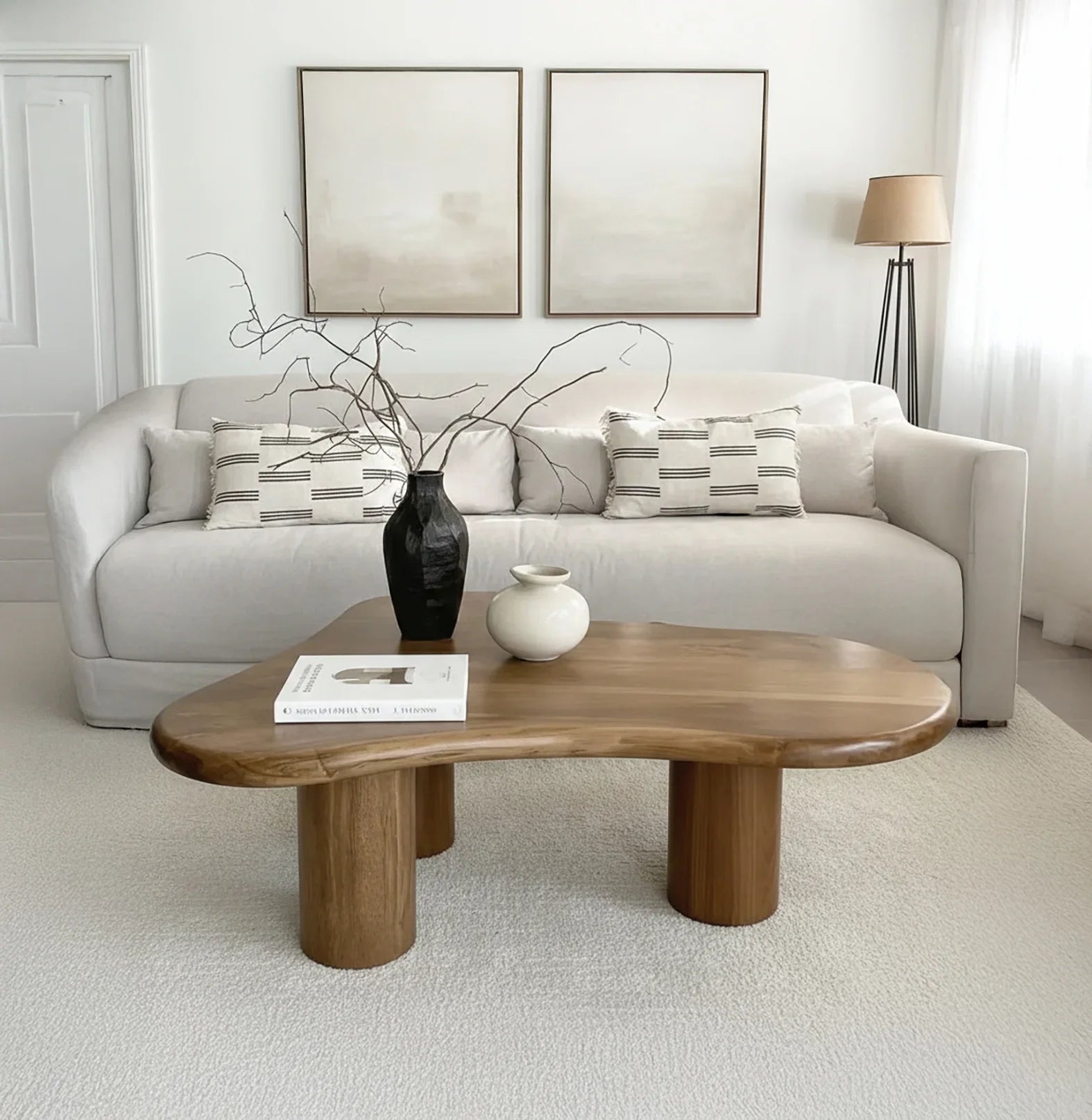 Modern living room with a solid wood live edge coffee table, neutral sofa, and minimalist decor
