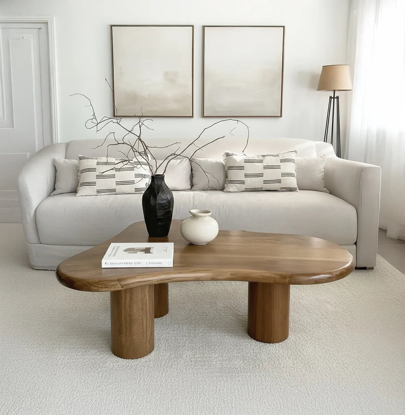 Modern living room with a solid wood live edge coffee table, neutral sofa, and minimalist decor