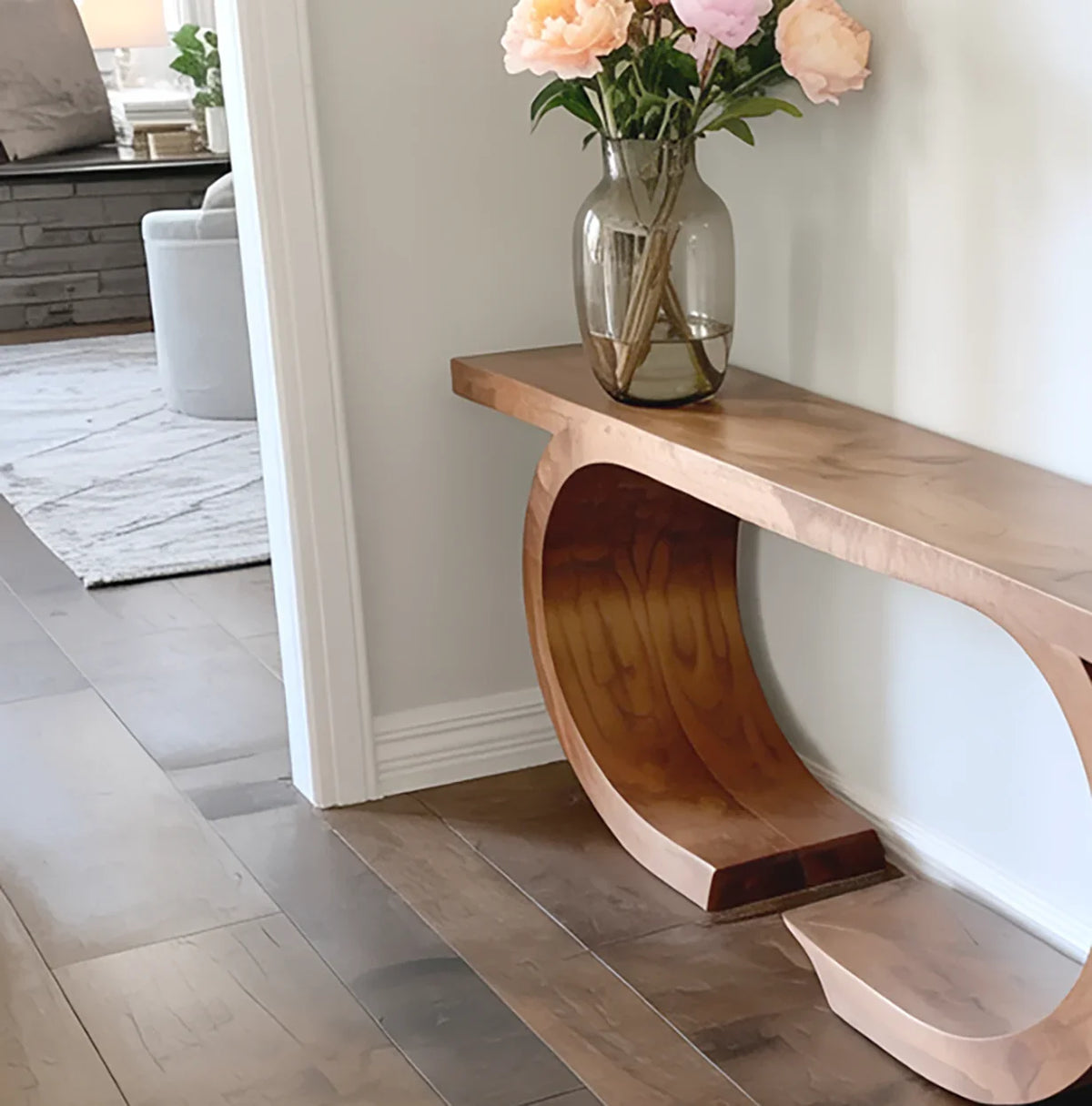 Solid wood console table with natural edge and sculptural base