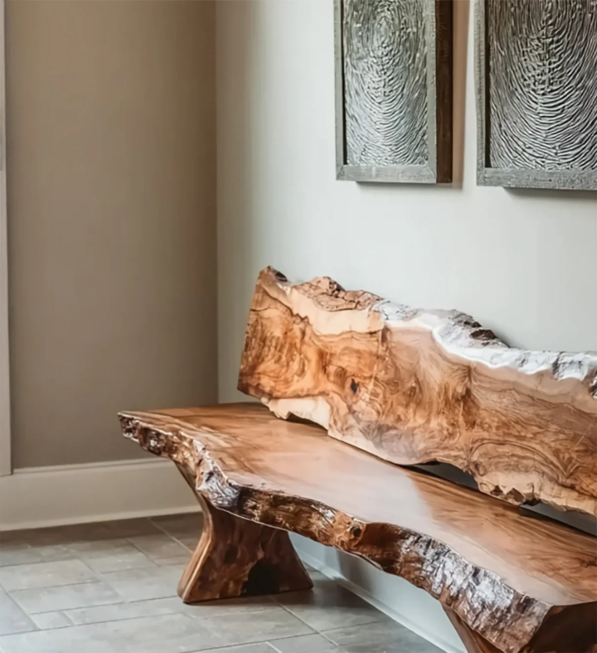 Handcrafted live edge wooden bench with natural wood grain against neutral wall with textured art