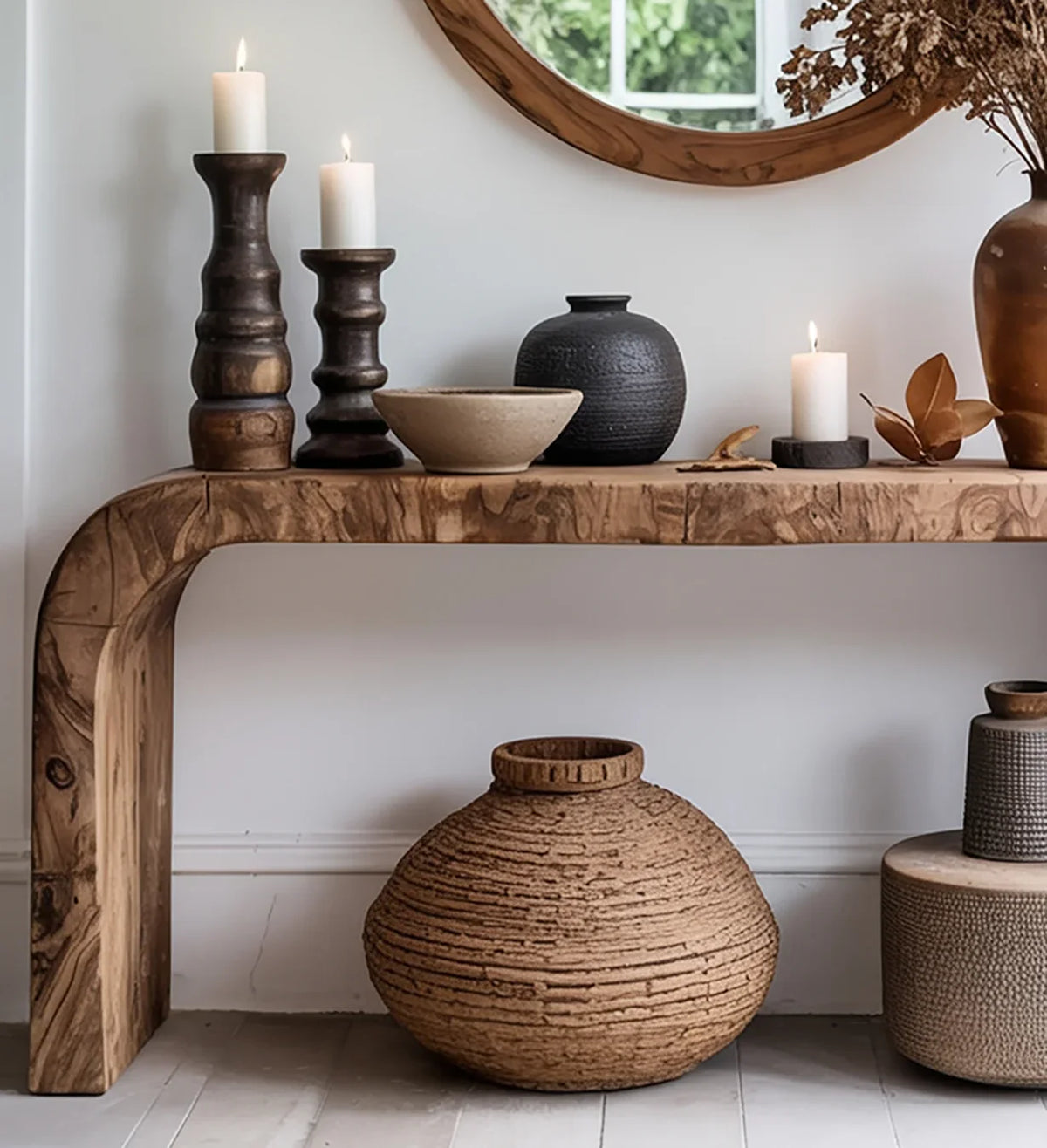 Live edge solid wood console table with candles, ceramic vases, and dried floral decor