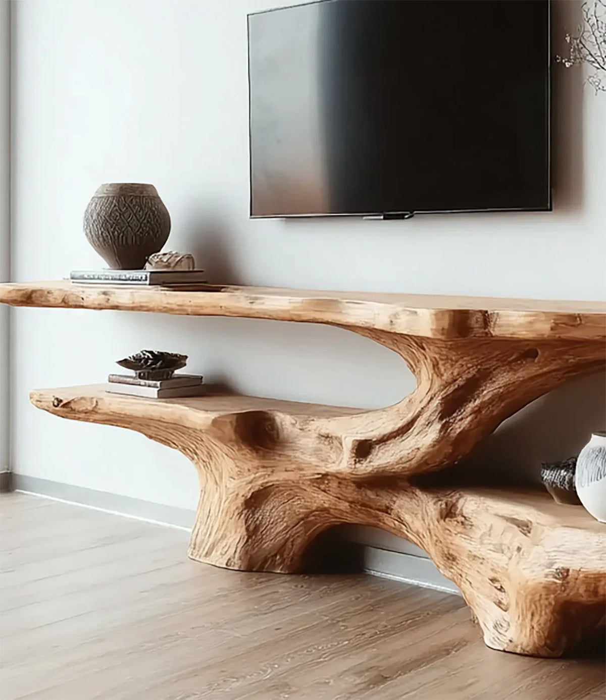 Live edge solid wood console table under wall-mounted TV with sculptural design and natural finish