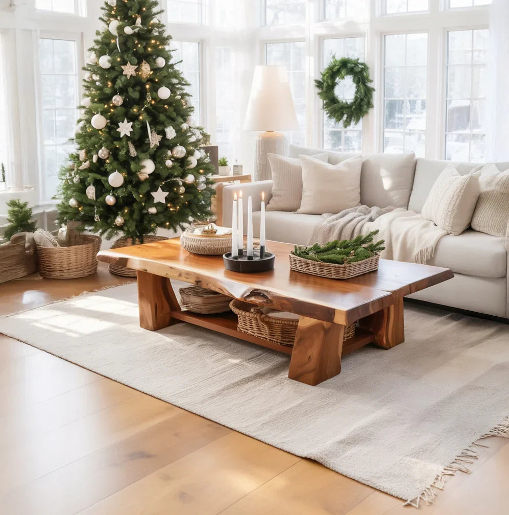 Cozy living room with decorated Christmas tree, natural wood coffee table, and beige sectional sofa