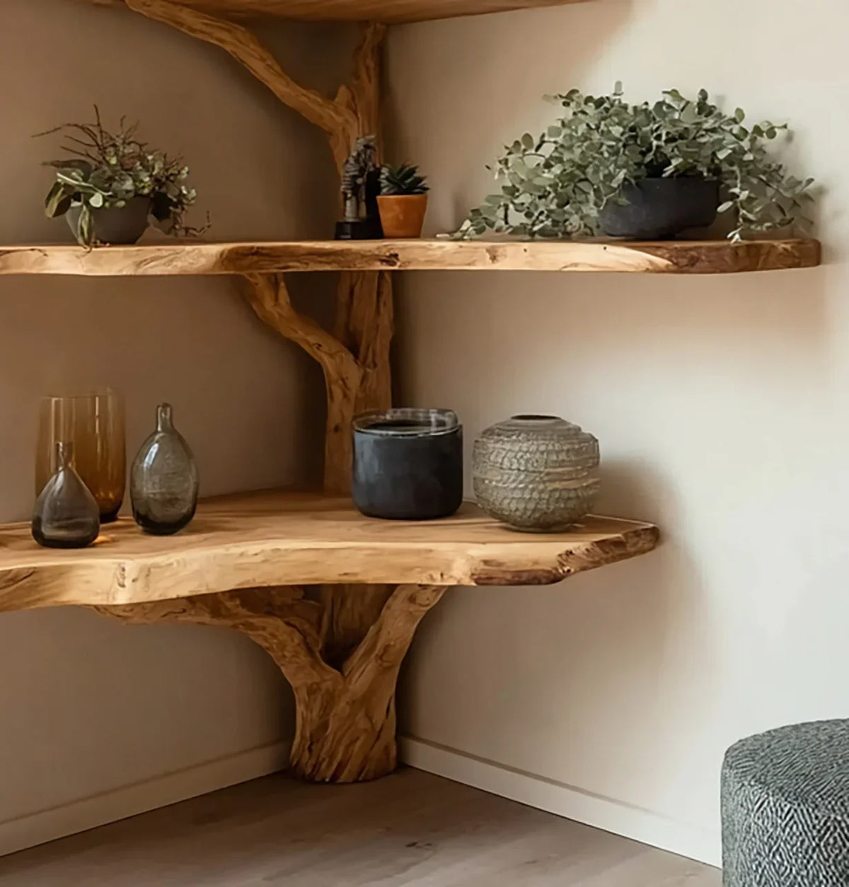 Corner display with rustic wooden shelves holding decorative glass vases and potted plants