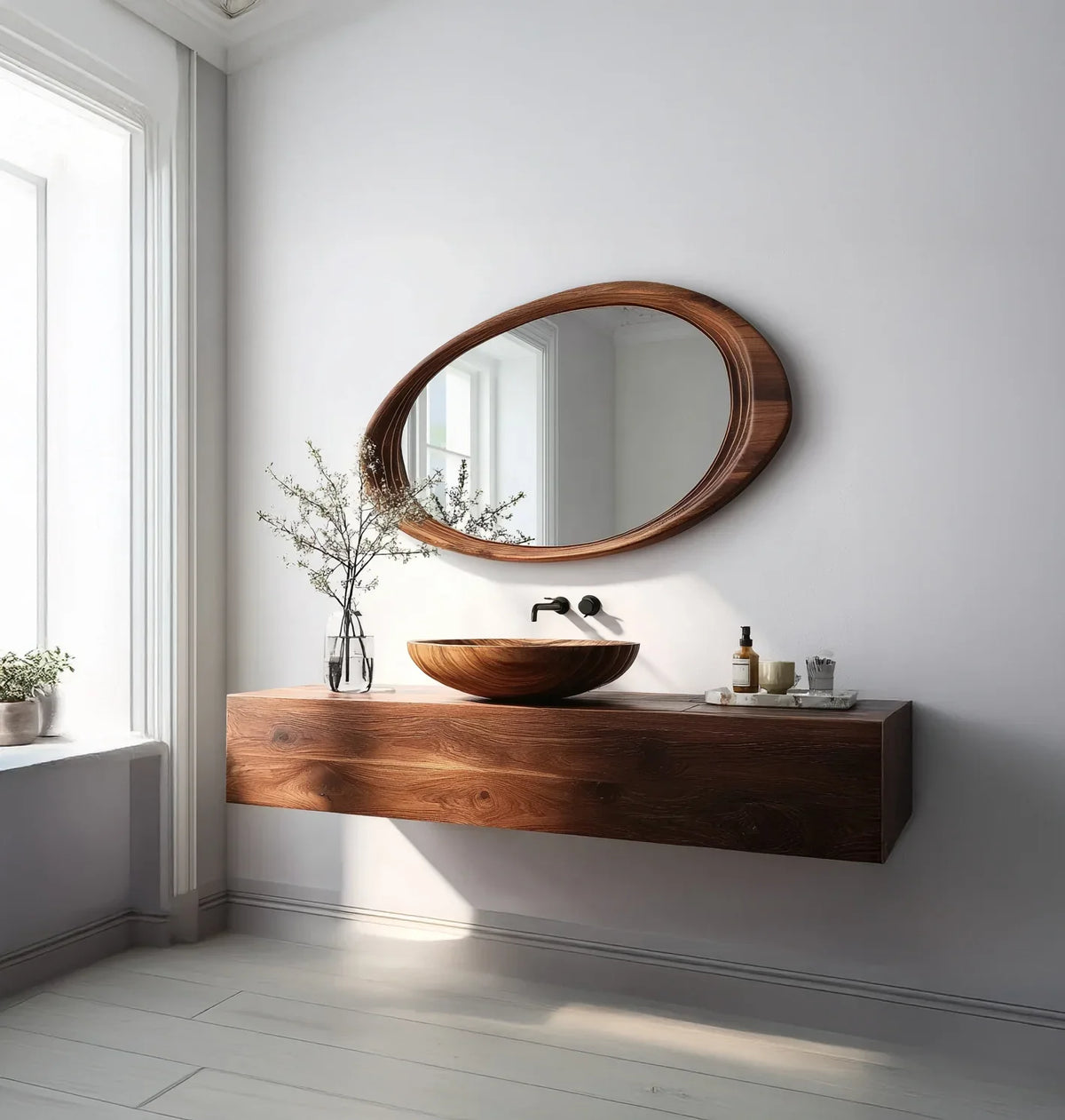 Modern bathroom with floating wooden vanity, oval wooden mirror, and glass vase with branches