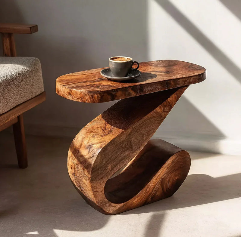 Modern sculptural wooden side table with a coffee cup and saucer in a sunlit room