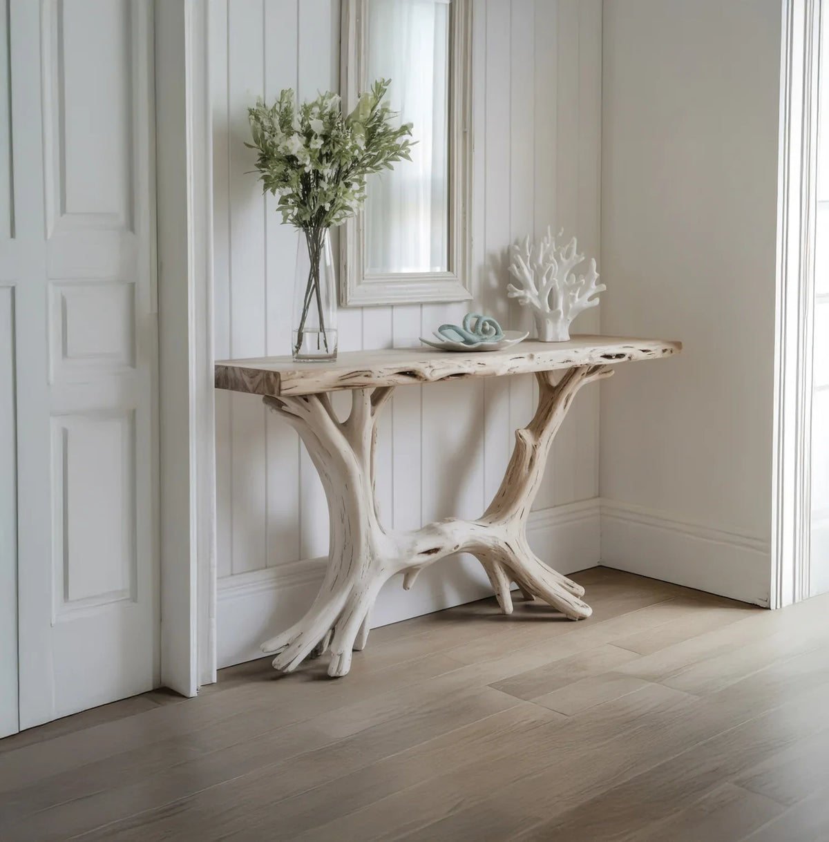 Live edge console table with natural wood branches in a bright entryway, decorated with flowers.