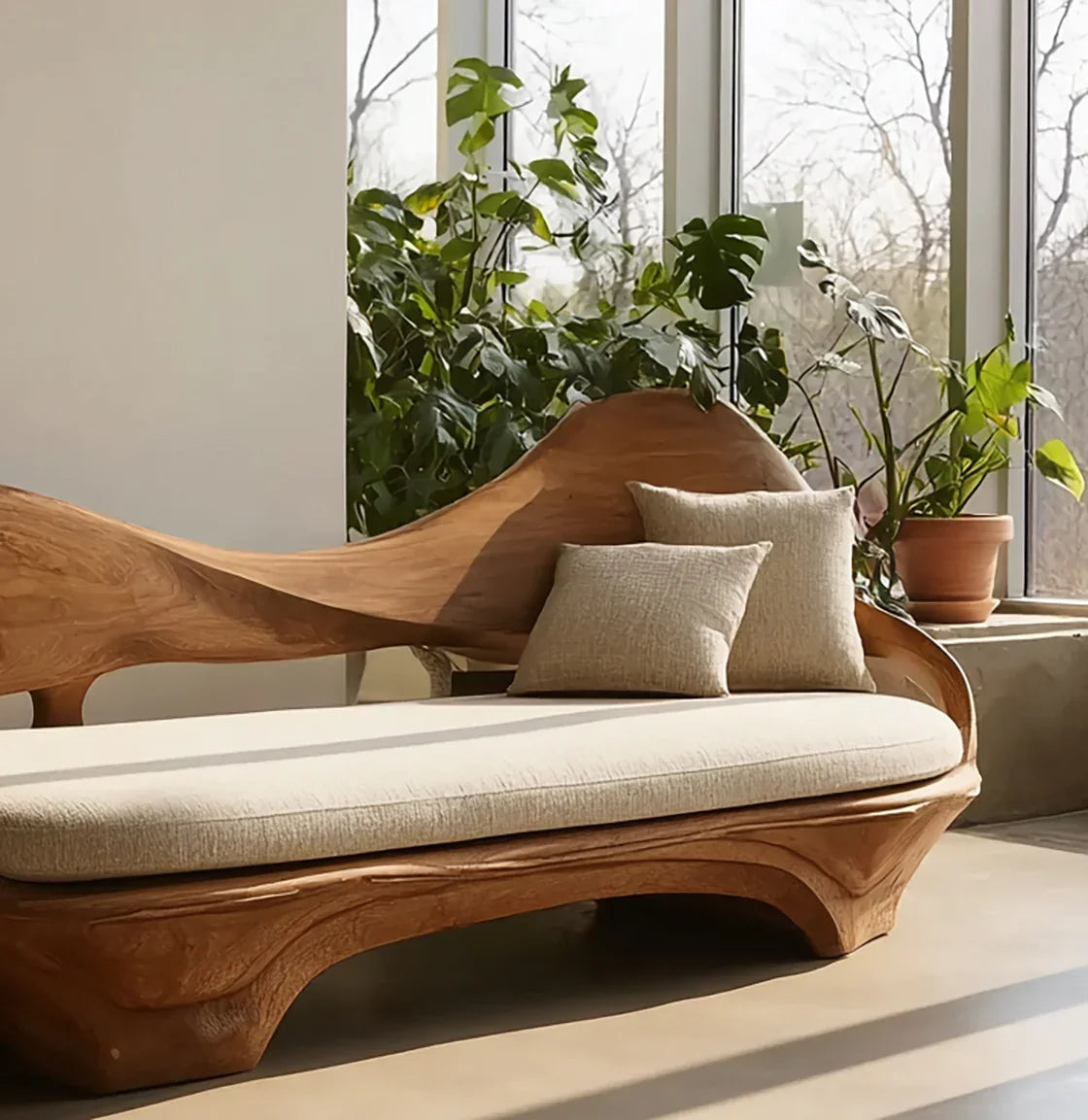 Sustainably crafted live edge wood sofa with beige cushion and pillows, near indoor plants