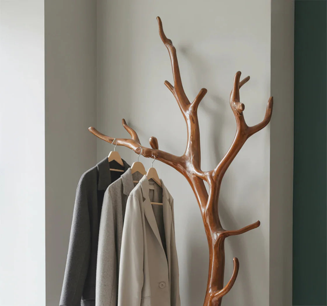 Solid wood tree branch coat rack with jackets hanging, modern entryway furniture