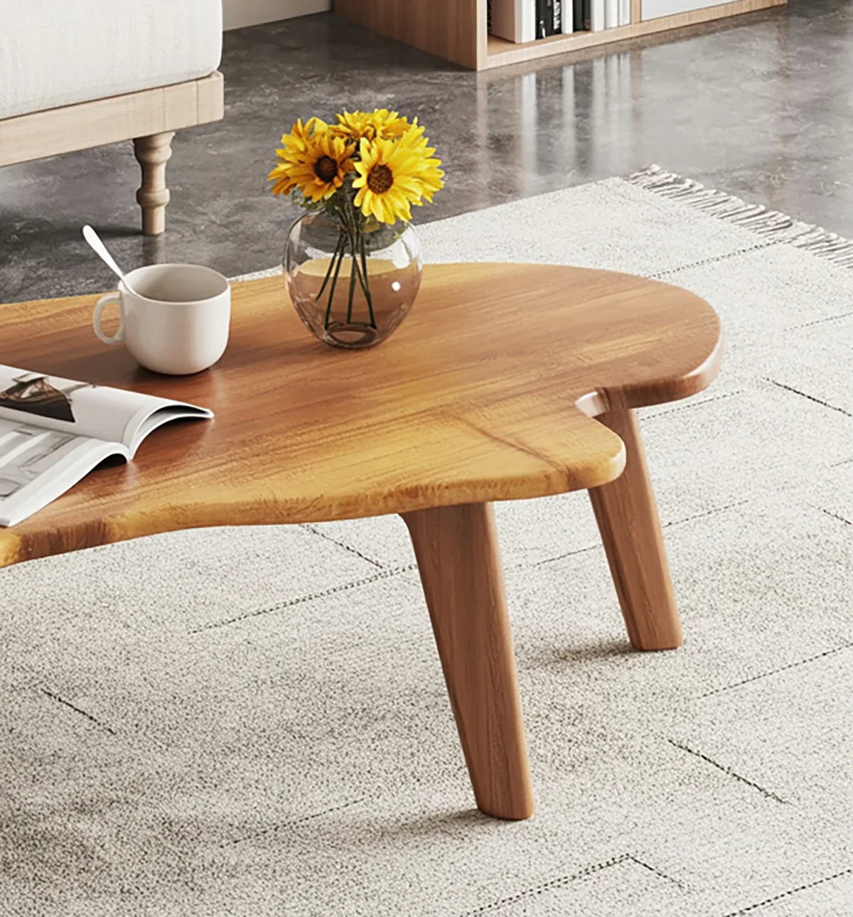 Live edge solid wood coffee table with sunflowers in vase, white mug, and open magazine