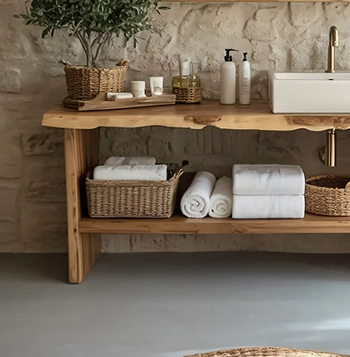 Live edge wood vanity with wicker baskets, towels, and bath accessories in a rustic bathroom