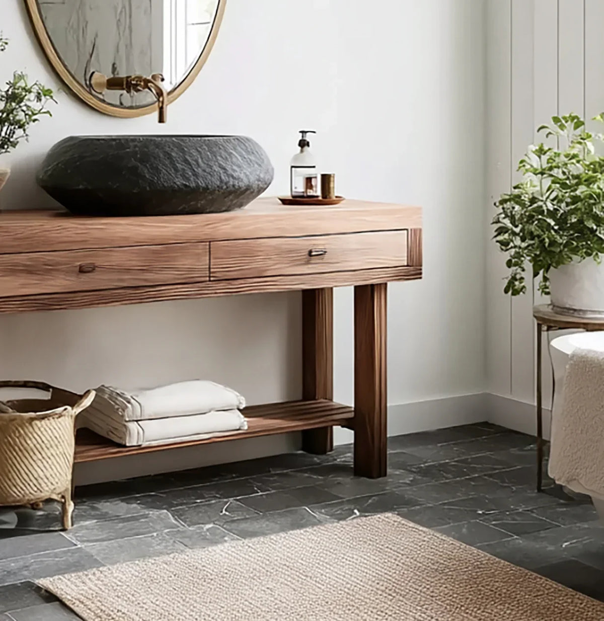 Solid wood bathroom vanity with live edge detail, stone sink, round mirror, and indoor plants
