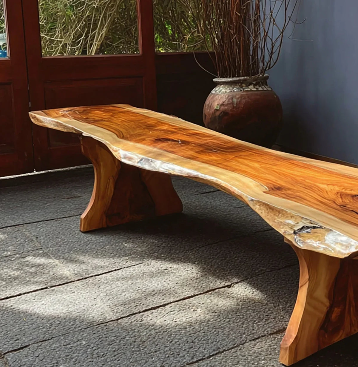 Live edge solid wood coffee table with natural finish in a modern indoor setting