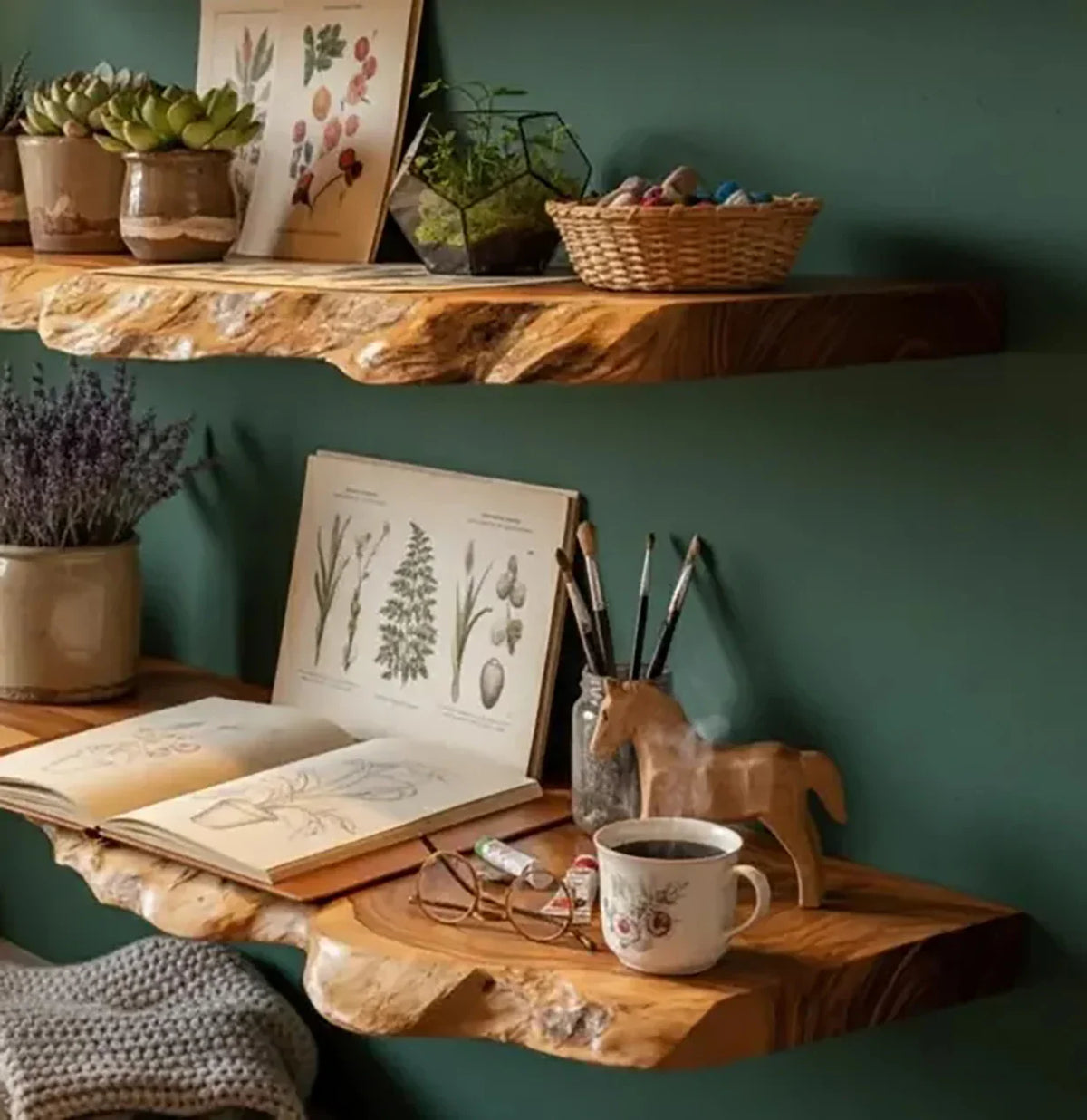Sustainably crafted live edge wooden floating shelves with books, plants, and art supplies on green wall