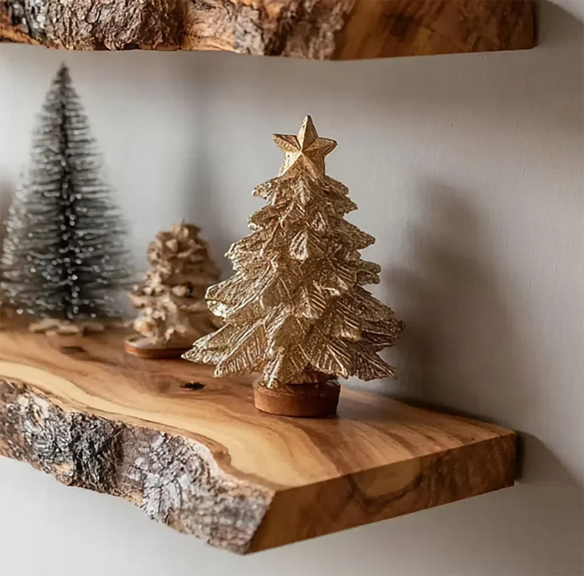Decorative miniature Christmas trees on rustic wooden floating shelf against gray wall