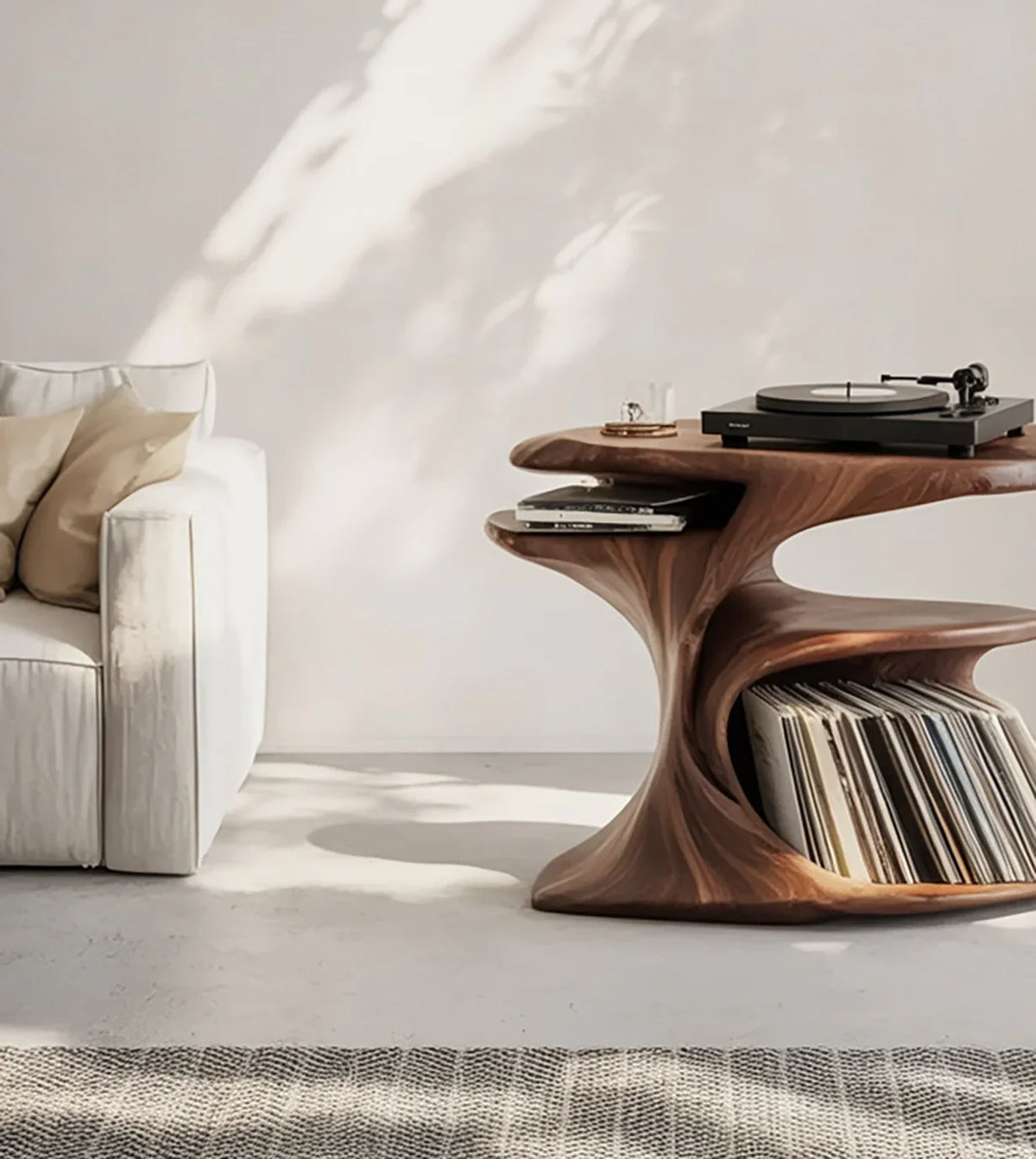 Modern living room with white sofa, sculptural wooden side table holding vinyl records and turntable