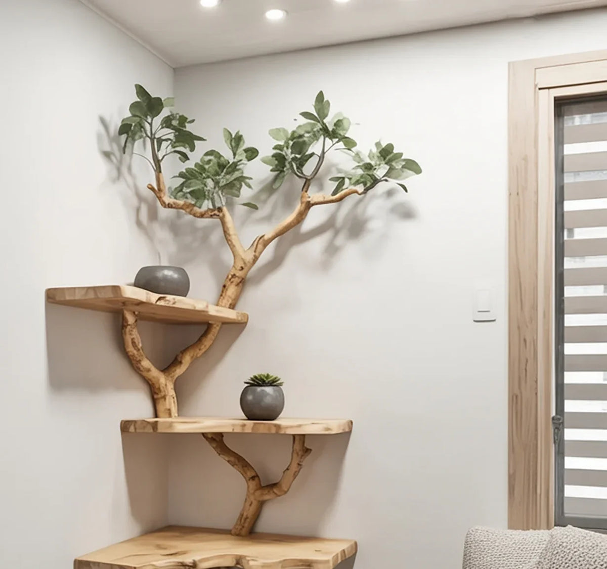 Natural wood corner shelves with branch-like supports and small potted plants in a modern white room