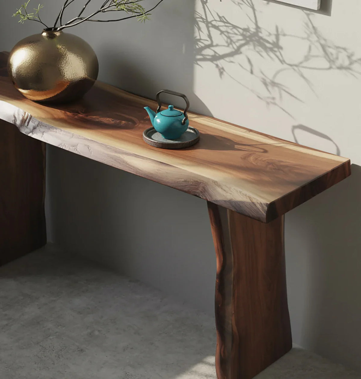 Live edge solid wood console table with decorative vase and teal teapot on top