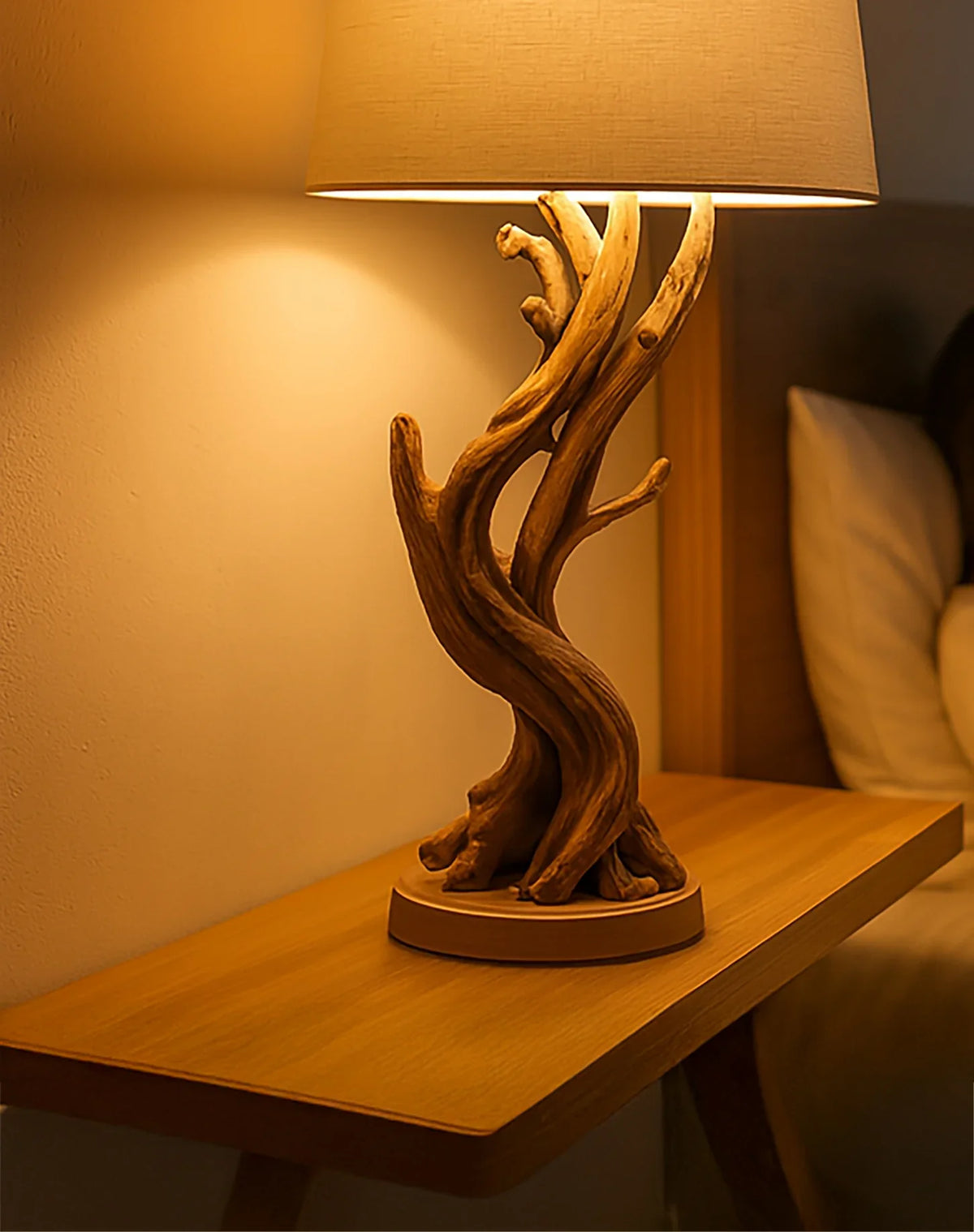 Sculptural wooden table lamp with natural branch base on bedside floating shelf