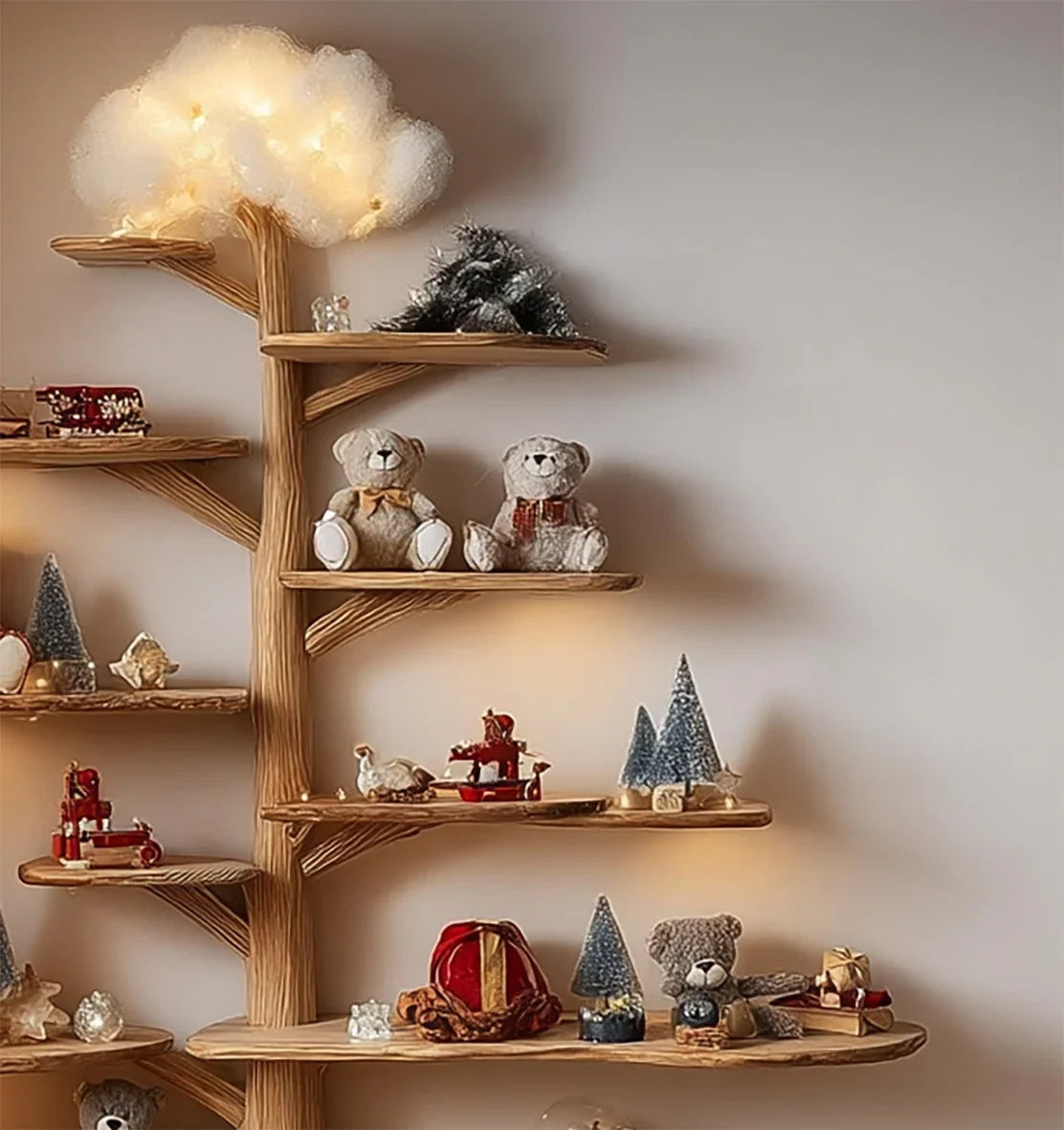 Tree-shaped wooden bookshelf decorated with teddy bears, toy trees, and soft lights