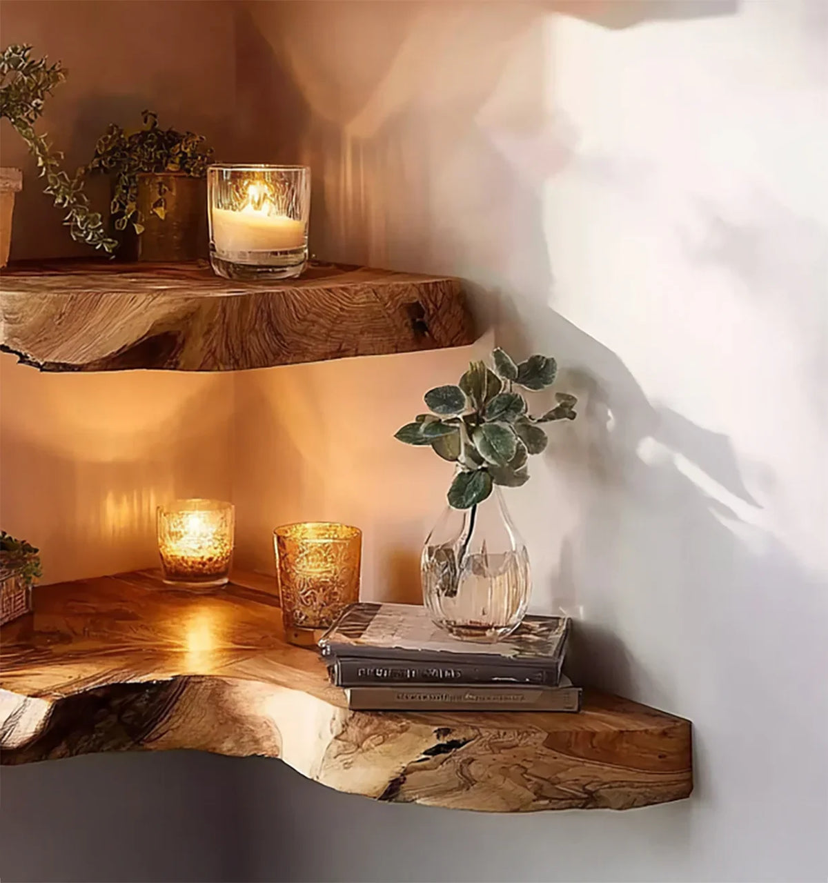 Rustic wooden corner shelves with lit candles, glass vase with green leaves, and stacked books