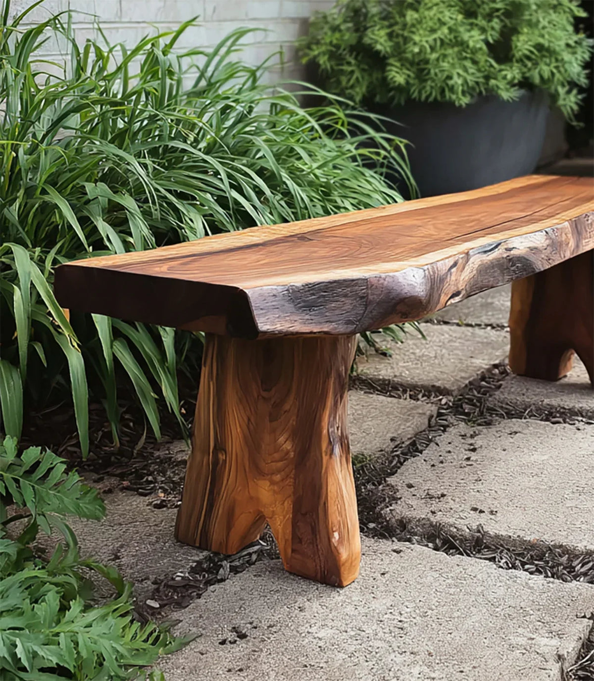 Handcrafted live edge wooden bench on stone patio surrounded by lush green plants