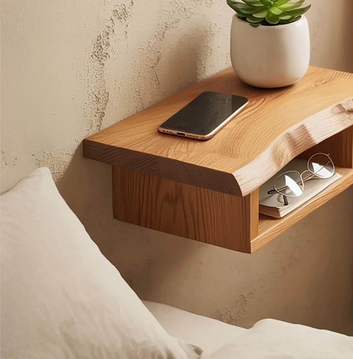 Sustainably crafted live edge floating wood shelf with phone, glasses, and potted plant