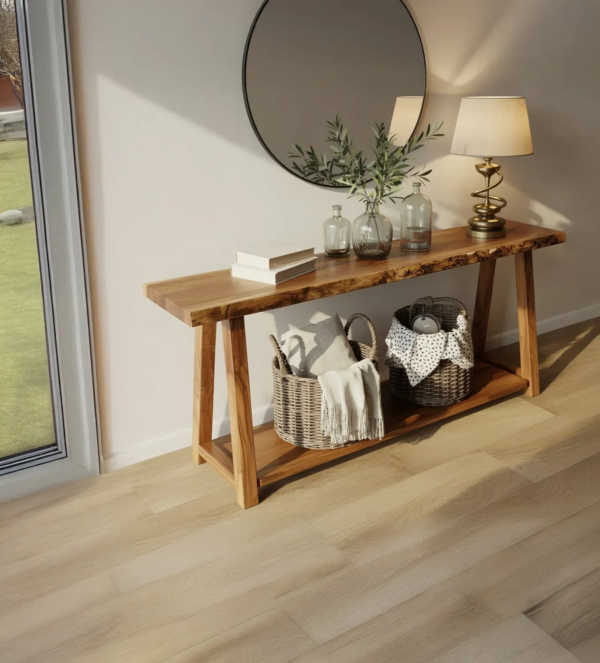 Modern wooden console table with decorative glass bottles, lamp, and round mirror in bright room